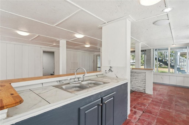 kitchen with a wealth of natural light, light countertops, and a sink