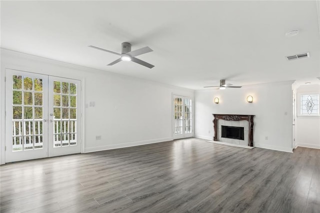 unfurnished living room with ceiling fan, wood finished floors, french doors, and visible vents