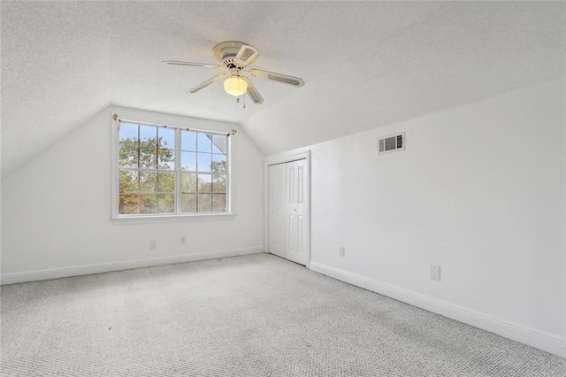 69027 Riverbend Dr, Covington, LA 70433 - bonus room featuring vaulted ceiling, a textured ceiling, carpet, and a ceiling fan