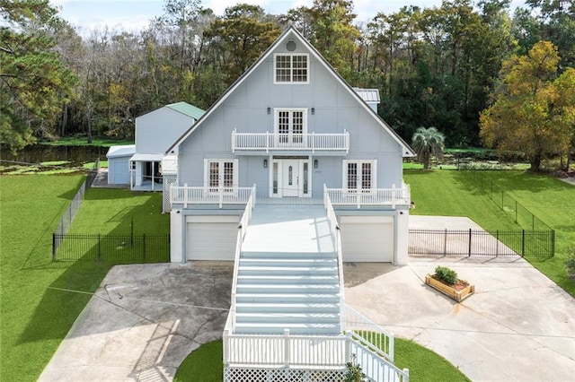 view of front facade with a balcony, driveway, board and batten siding, an attached garage, and french doors