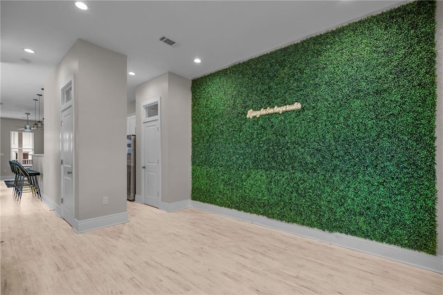 interior space with light hardwood / wood-style floors and an inviting chandelier