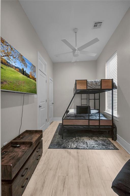 bedroom with light wood-type flooring and ceiling fan