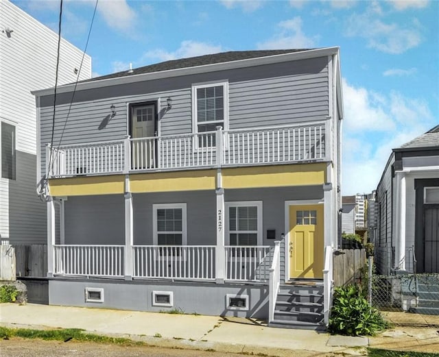 exterior space featuring a balcony and covered porch