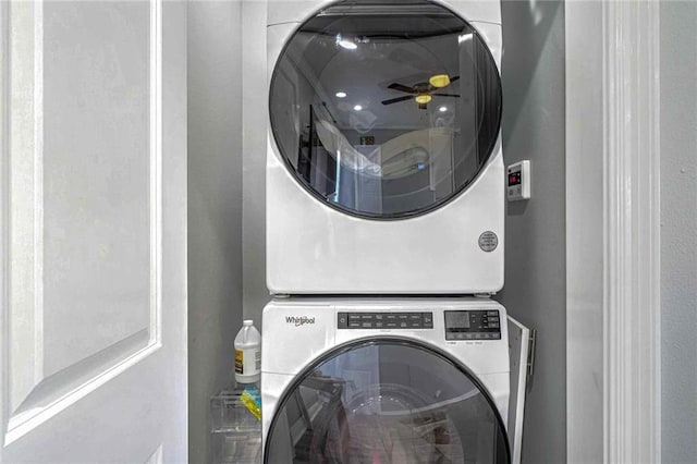 laundry room featuring stacked washer / drying machine