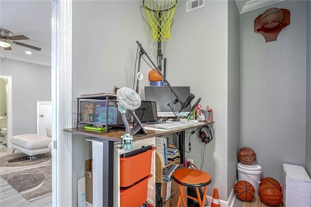 home office with hardwood / wood-style flooring, ceiling fan, and crown molding