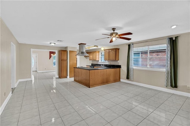 kitchen featuring range hood, ceiling fan, light tile patterned flooring, and kitchen peninsula