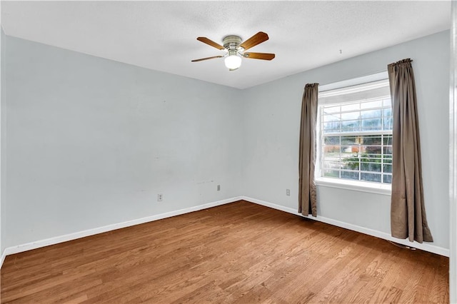 empty room with ceiling fan and wood-type flooring