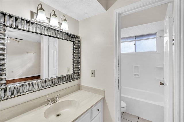 full bathroom featuring bathtub / shower combination, a textured ceiling, toilet, vanity, and tile patterned flooring