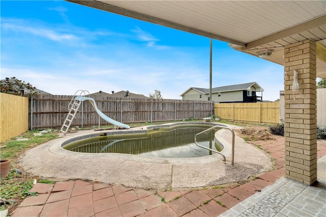 exterior space with a water slide and a patio