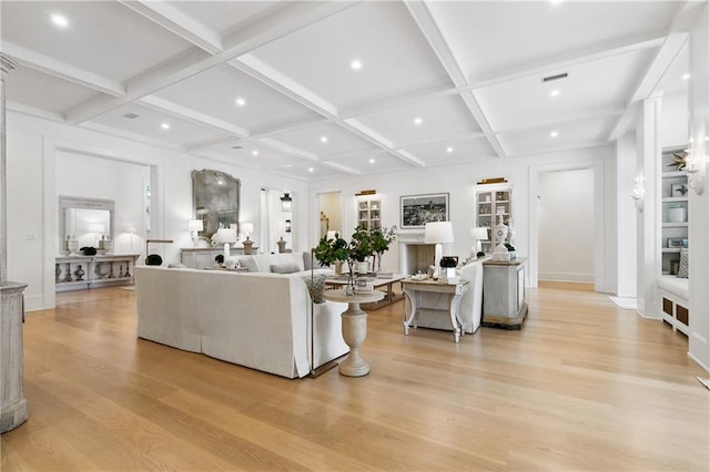 living room with beamed ceiling, coffered ceiling, and light wood-type flooring