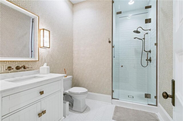 bathroom with an enclosed shower, vanity, and toilet