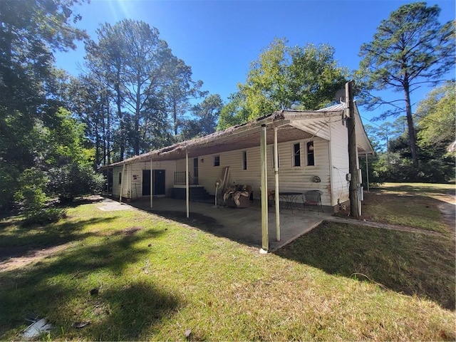 view of home's exterior with a yard and a patio area