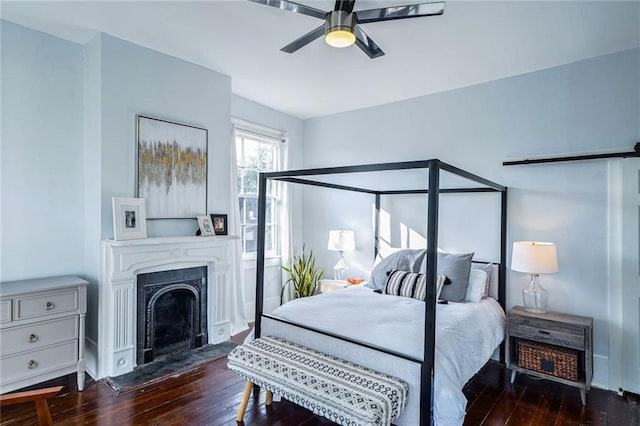 bedroom with dark wood-type flooring and ceiling fan