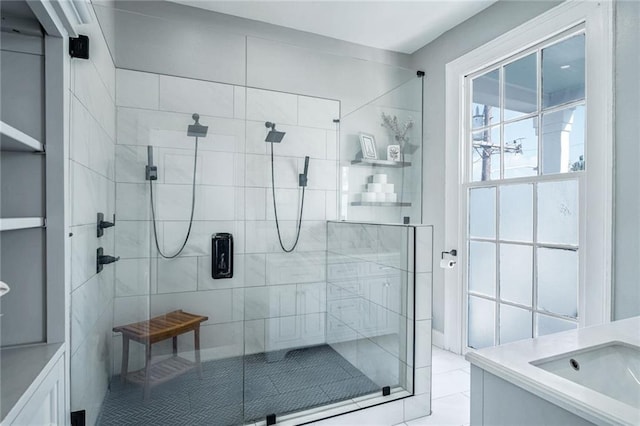 bathroom with a shower with door, sink, and tile patterned floors