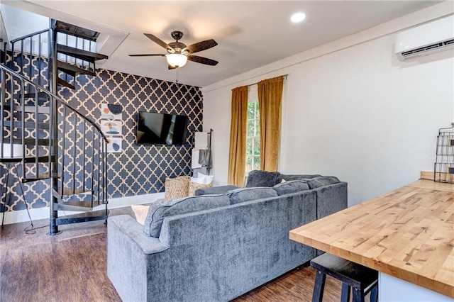 living room with ceiling fan, an AC wall unit, and dark hardwood / wood-style flooring