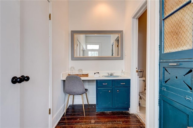 bathroom featuring vanity, hardwood / wood-style flooring, and toilet