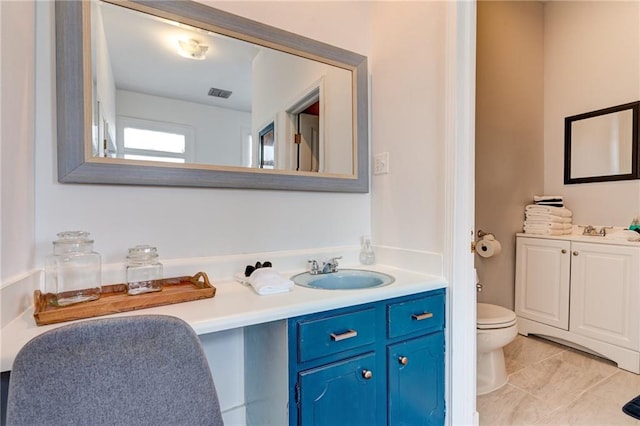 bathroom featuring vanity and toilet