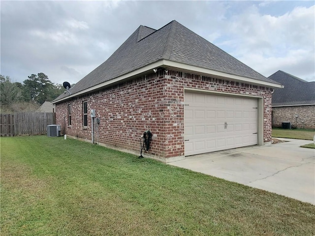 view of side of home with central air condition unit, a lawn, and a garage