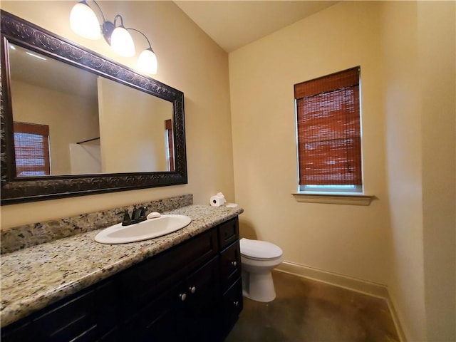 bathroom featuring toilet and vanity