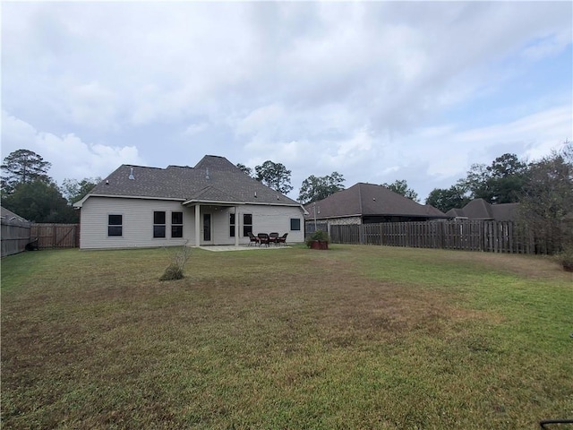 rear view of house with a patio area and a yard