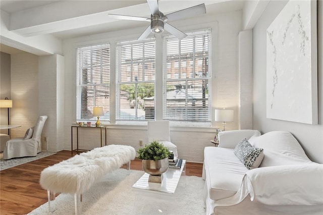 living area with hardwood / wood-style floors and ceiling fan