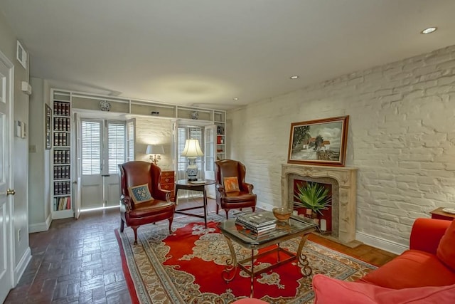 sitting room with dark parquet floors and a premium fireplace