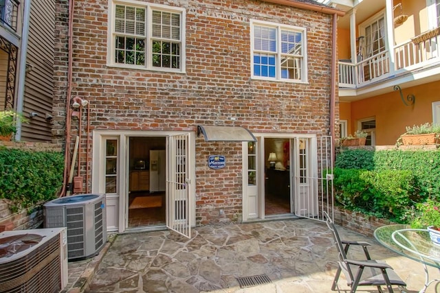 exterior space featuring a patio, cooling unit, and a balcony