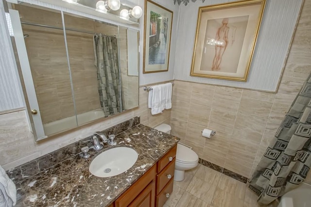 full bathroom with shower / bath combination with curtain, toilet, tile walls, and vanity