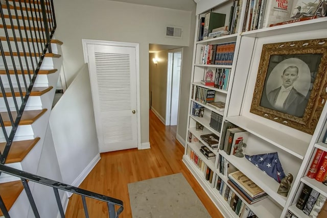 hall with hardwood / wood-style flooring