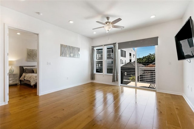 empty room featuring ceiling fan and hardwood / wood-style floors