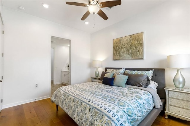 bedroom with ceiling fan, dark hardwood / wood-style flooring, and ensuite bathroom