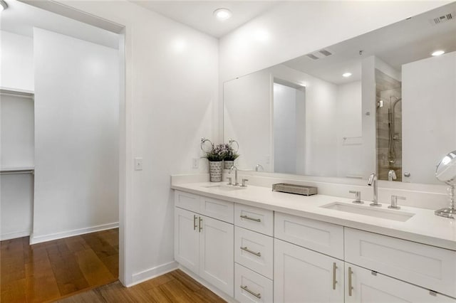 bathroom with vanity, wood-type flooring, and an enclosed shower