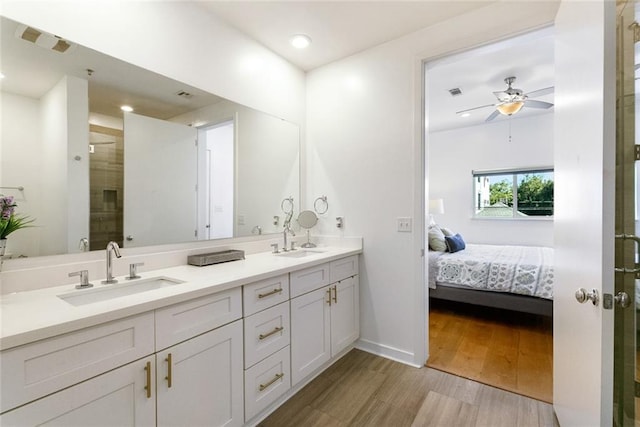 bathroom with ceiling fan, hardwood / wood-style floors, vanity, and a shower with shower door