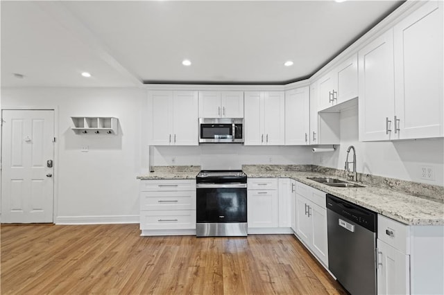 kitchen featuring light hardwood / wood-style flooring, white cabinets, stainless steel appliances, and sink