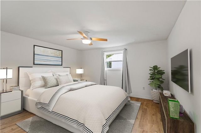 bedroom featuring ceiling fan and light hardwood / wood-style flooring