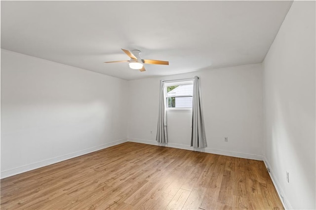 spare room featuring light hardwood / wood-style flooring and ceiling fan