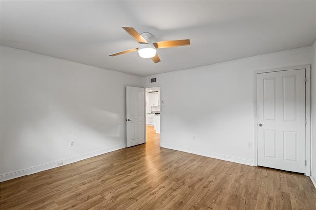 spare room with light hardwood / wood-style floors and ceiling fan