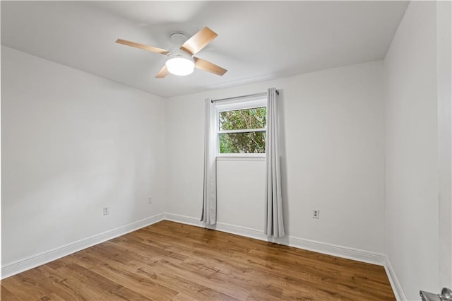 spare room with ceiling fan and light wood-type flooring