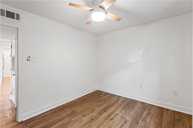 spare room featuring hardwood / wood-style flooring and ceiling fan