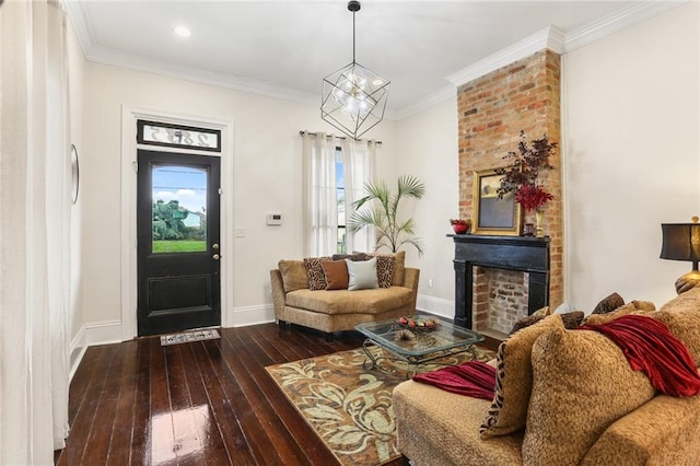 interior space with an inviting chandelier, wood-type flooring, ornamental molding, and a fireplace