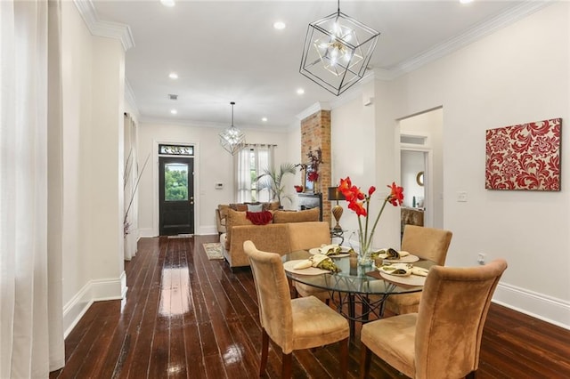 dining space featuring dark wood-type flooring, a chandelier, and crown molding