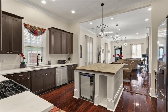 2835 Danneel St, New Orleans, LA 70115 - kitchen with a sink, stainless steel dishwasher, dark brown cabinets, dark wood finished floors, and recessed lighting