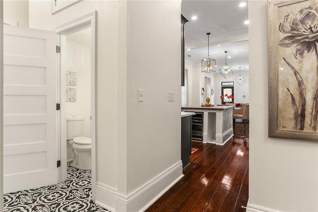 2835 Danneel St, New Orleans, LA 70115 - hall with built in shelves, recessed lighting, baseboards, dark wood finished floors, and beverage cooler