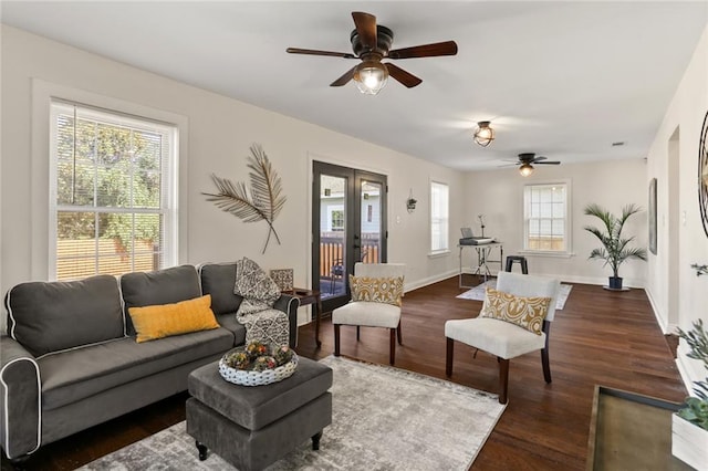 living room featuring ceiling fan, a healthy amount of sunlight, and dark hardwood / wood-style floors