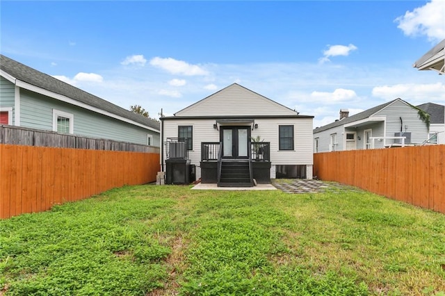 rear view of property with a yard