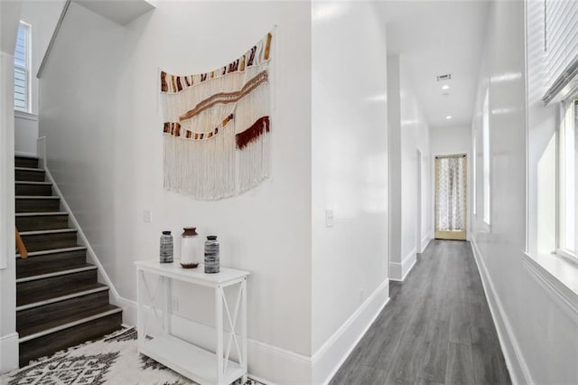 hallway with hardwood / wood-style flooring