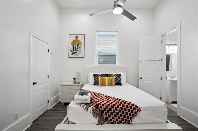 bedroom featuring dark wood-type flooring, ceiling fan, ensuite bath, and lofted ceiling