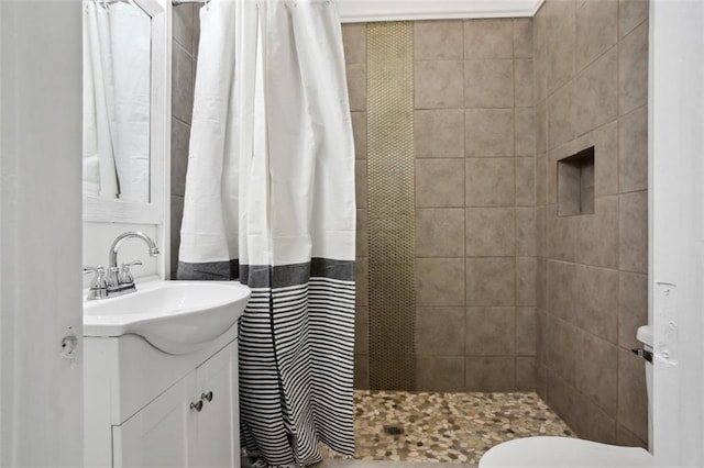 bathroom featuring curtained shower, vanity, and toilet