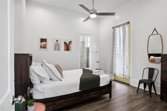 bedroom with a towering ceiling, ceiling fan, dark hardwood / wood-style floors, and connected bathroom