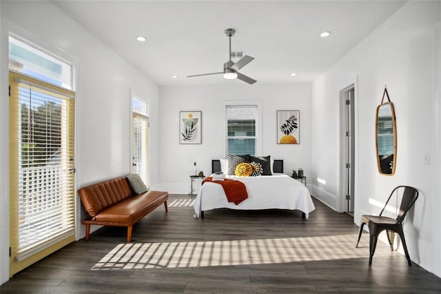 bedroom with dark wood-type flooring, multiple windows, and ceiling fan